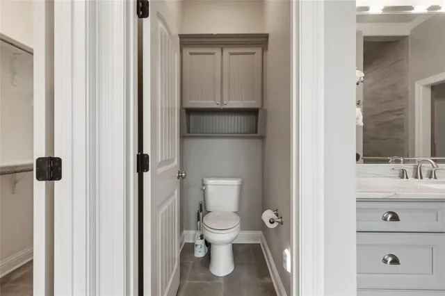 a bathroom with a toilet a sink and a mirror