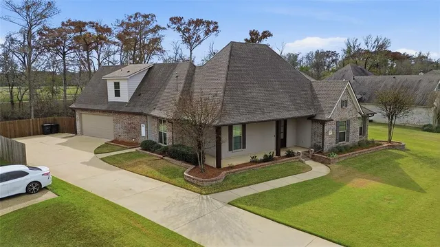 a view of a house with backyard and sitting area
