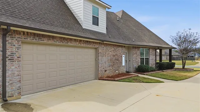 a view of a house with a yard and garage