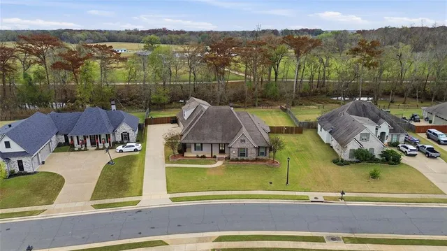 an aerial view of residential houses with outdoor space and city view