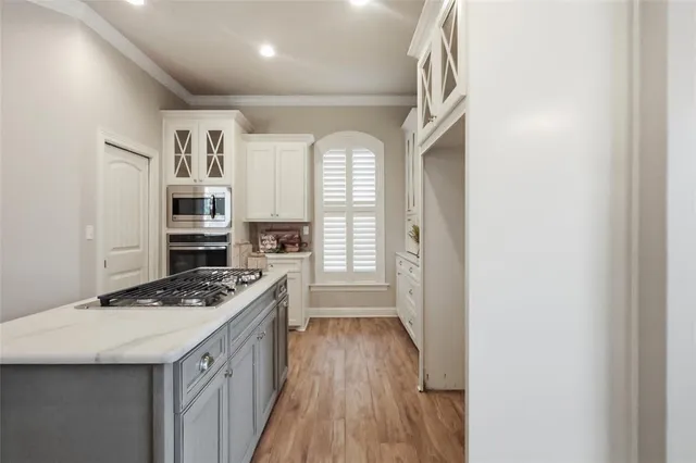 a kitchen with stainless steel appliances granite countertop a stove and a refrigerator