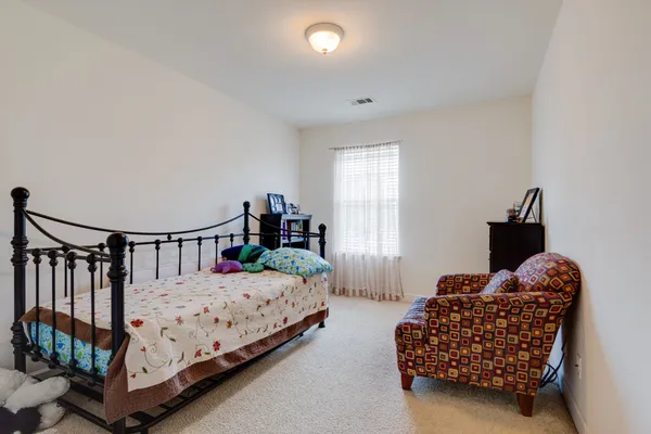 a bedroom with bed and a window