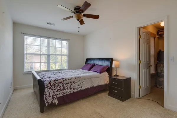 a bedroom with a bed and a window