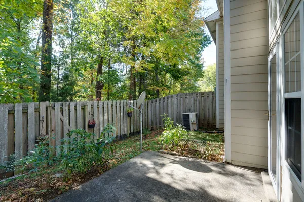 a view of small garden with wooden fence