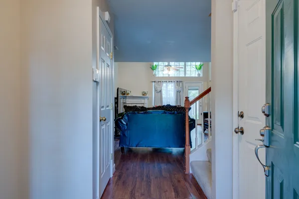 a view of entryway and hall with wooden floor