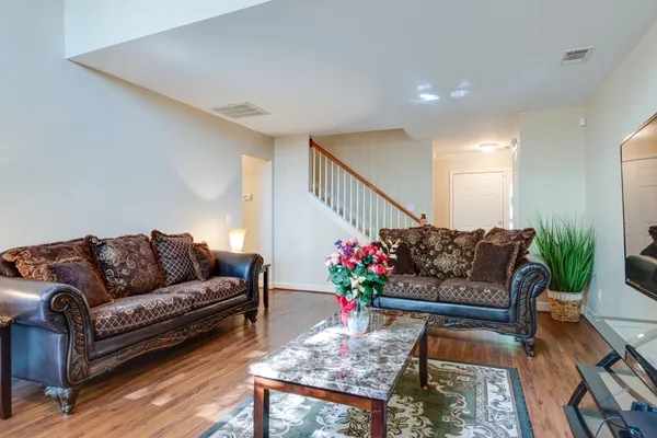 a living room with furniture and a potted plant