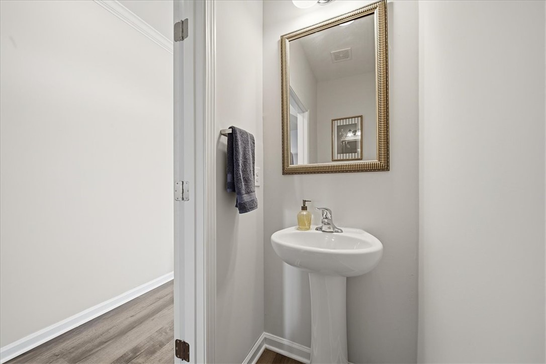 403 Seaborn Circle Pendleton, SC 29670 - Photo 5 of 47 This clean and functional powder room features a pedestal sink, framed mirror, and crown molding.
