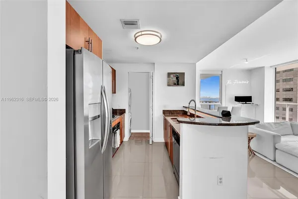 a bathroom with a sink a toilet a mirror and shower