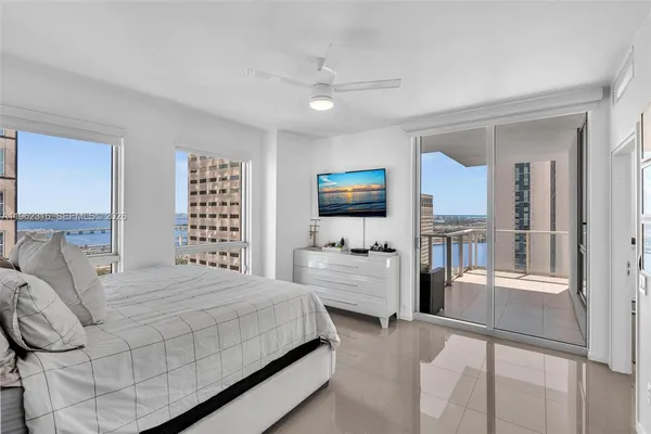 a bathroom with a sink a toilet a mirror a bathtub and shower