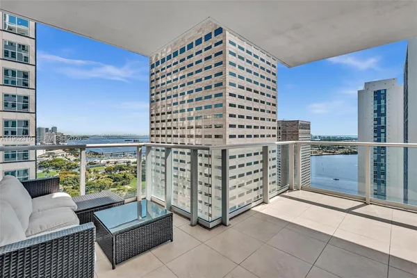a kitchen with stainless steel appliances granite countertop a sink a refrigerator and a granite counter tops