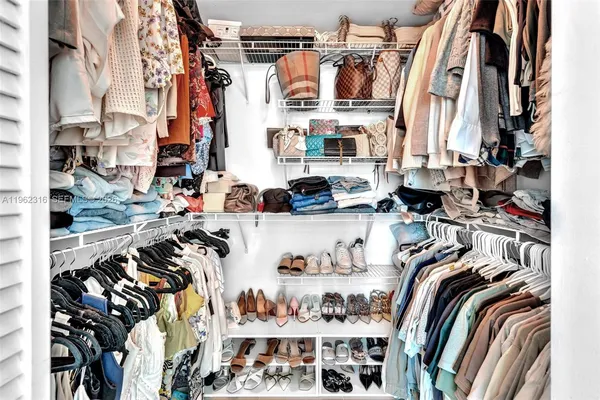 a room with stainless steel appliances a refrigerator a sink a microwave a counter top and cabinets