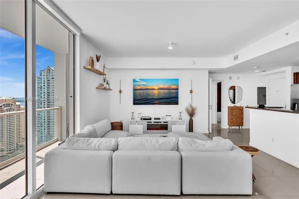 a bedroom with a large bed and a flat screen tv