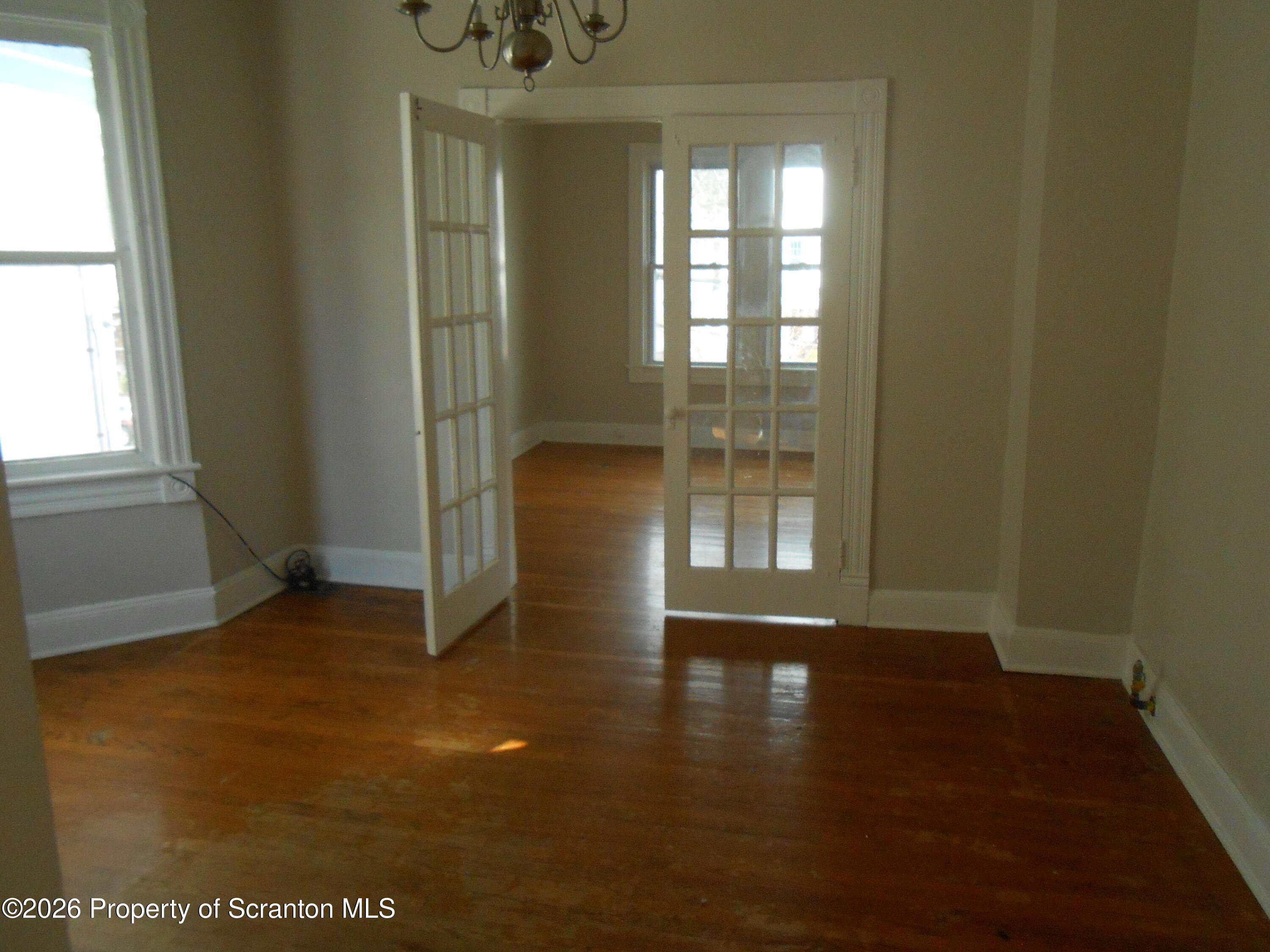 622 North 624 Main, Unit 4 Scranton, PA 18504 - Photo 14 of 19 an empty room with wooden floor and windows