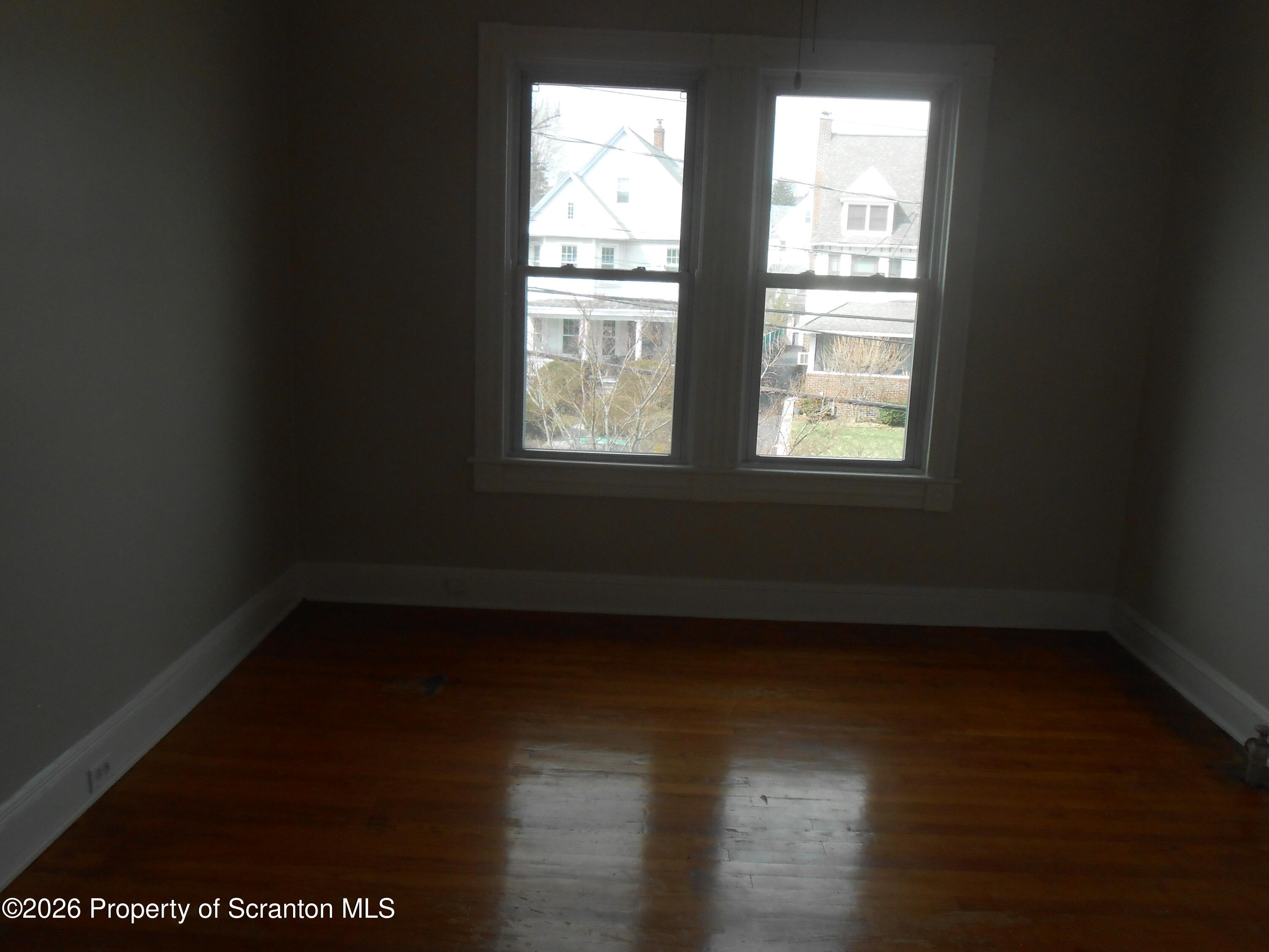 622 North 624 Main, Unit 4 Scranton, PA 18504 - Photo 16 of 19 a view of an empty room with wooden floor and a window