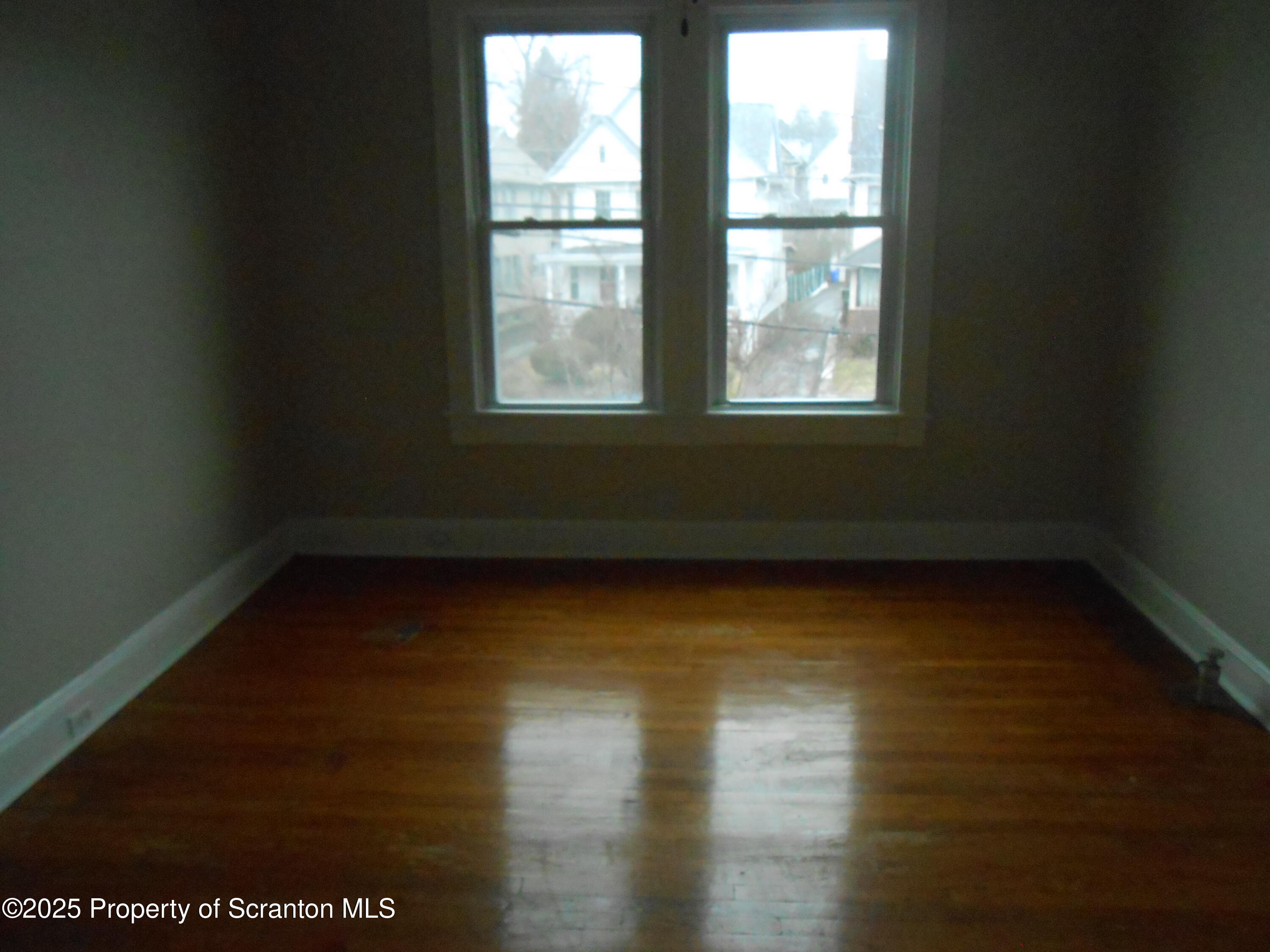 622 North 624 Main, Unit 4 Scranton, PA 18504 - Photo 18 of 19 a view of an empty room with wooden floor and a window