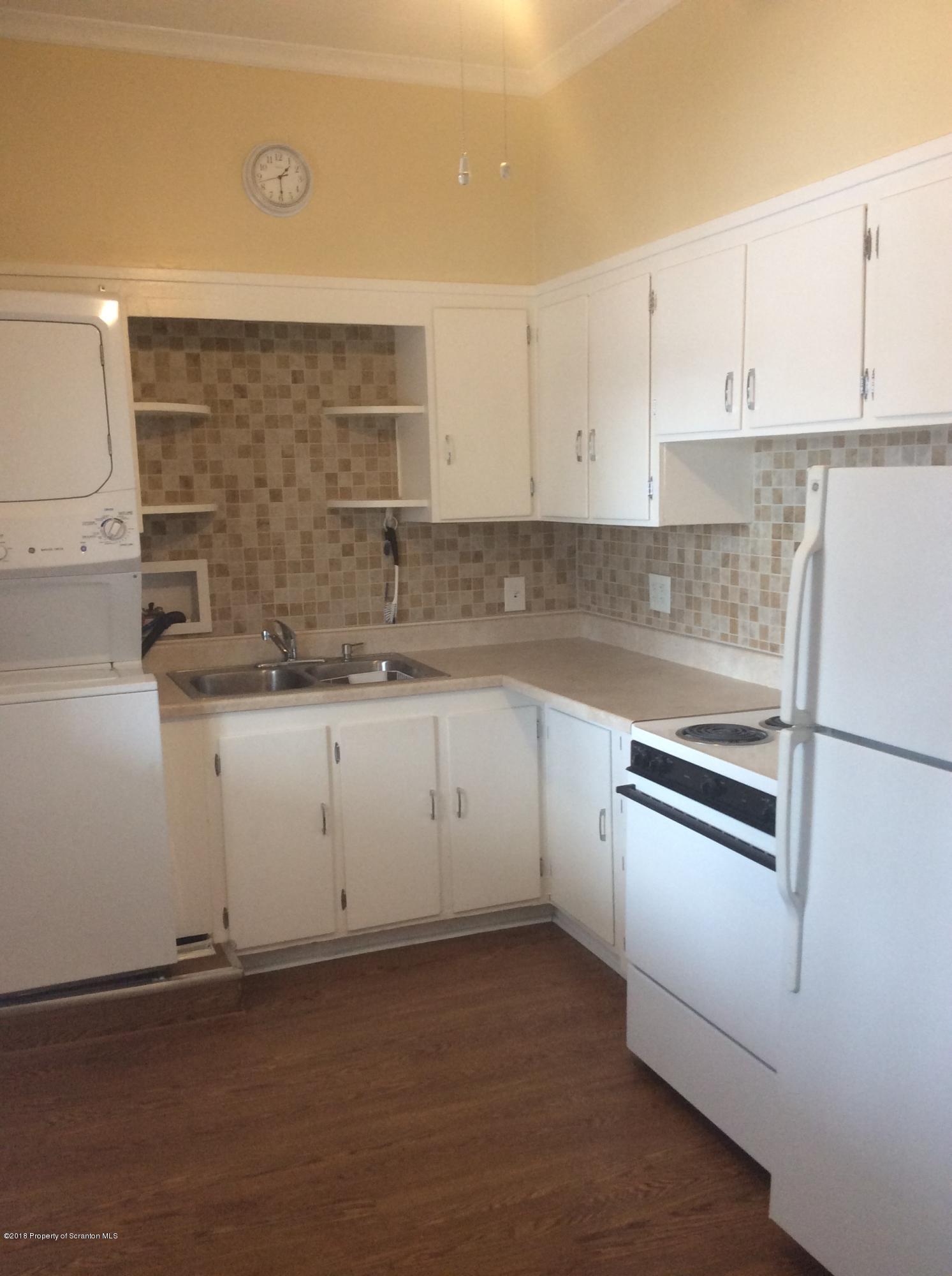 622 North 624 Main, Unit 4 Scranton, PA 18504 - Photo 2 of 19 a kitchen with granite countertop white cabinets and white appliances