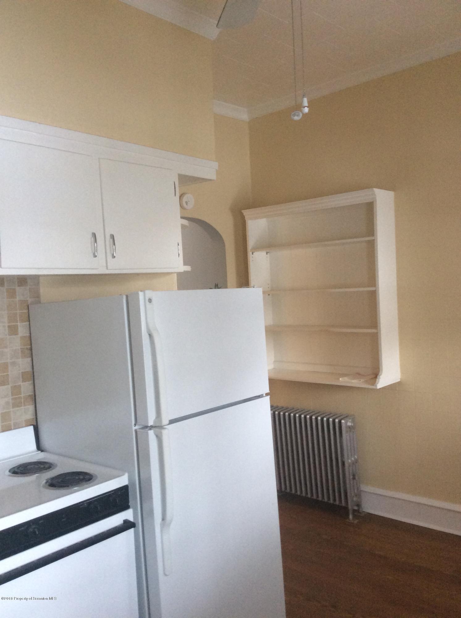 622 North 624 Main, Unit 4 Scranton, PA 18504 - Photo 4 of 19 a white refrigerator freezer and a stove sitting inside of a kitchen