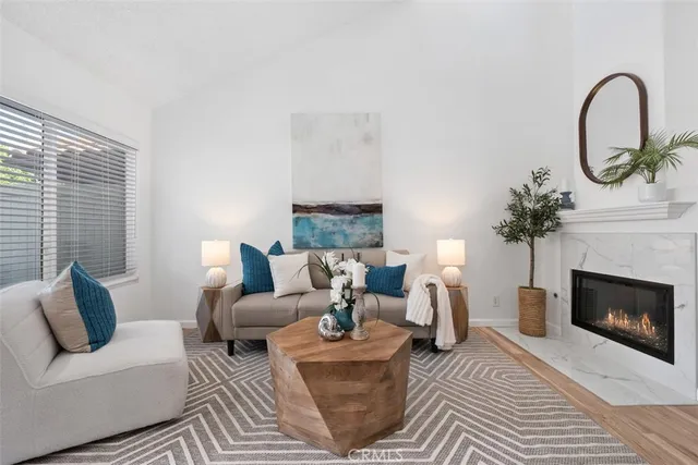 a living room with furniture a window and a fireplace