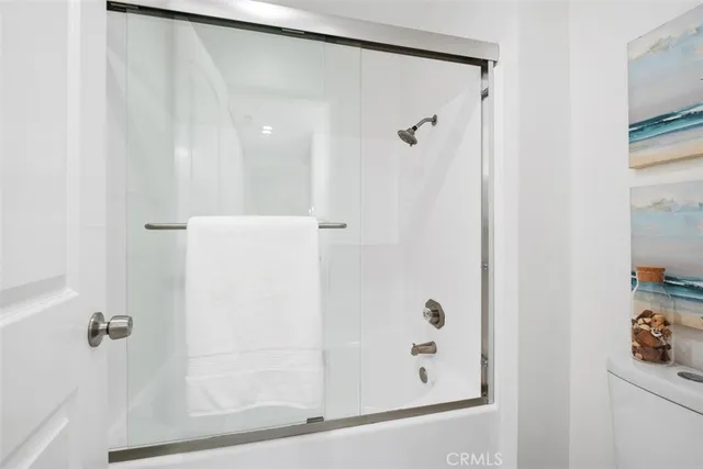 a bathroom with a glass shower door