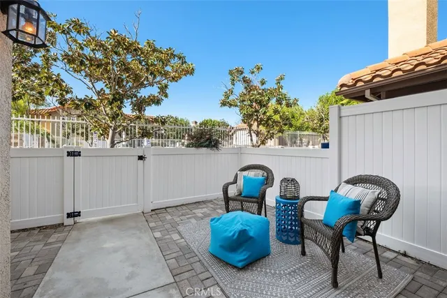 a backyard of a house with table and chairs