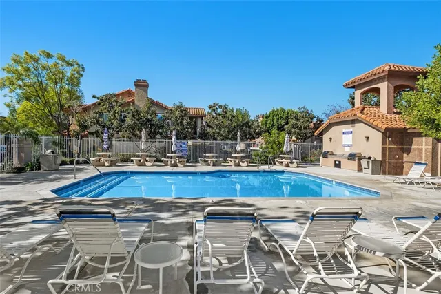 a view of swimming pool with outdoor seating and deck