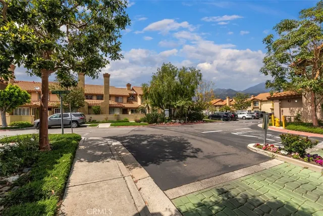 a city street lined with buildings and trees