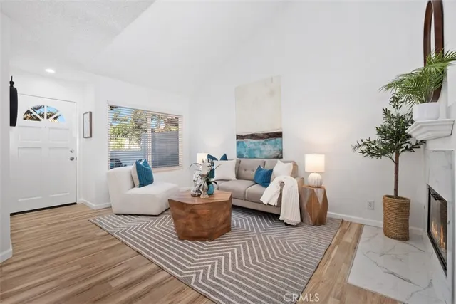 a living room with furniture and a potted plant