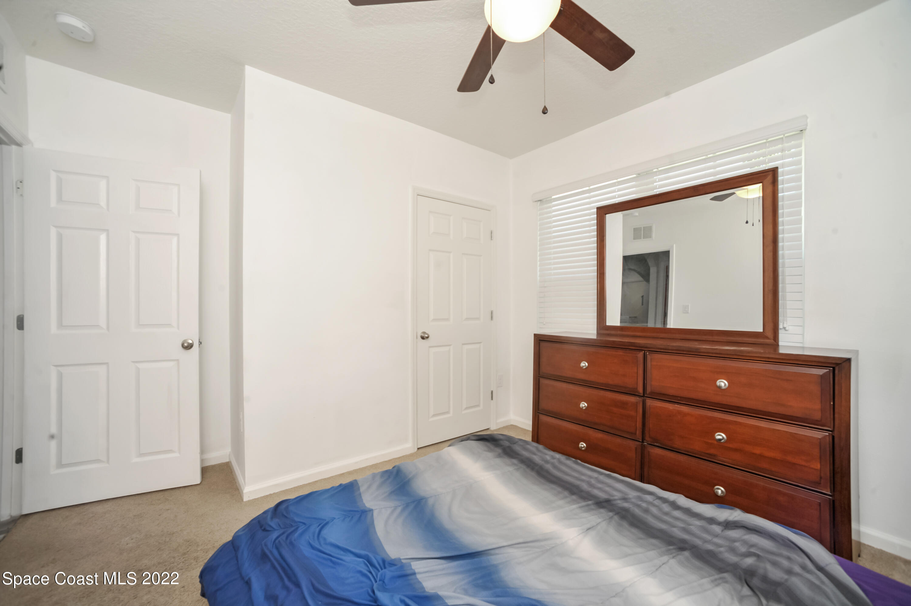 4720 Pagosa Springs Circle Melbourne, FL 32901 - Photo 11 of 24 a room with a bed and a dresser
