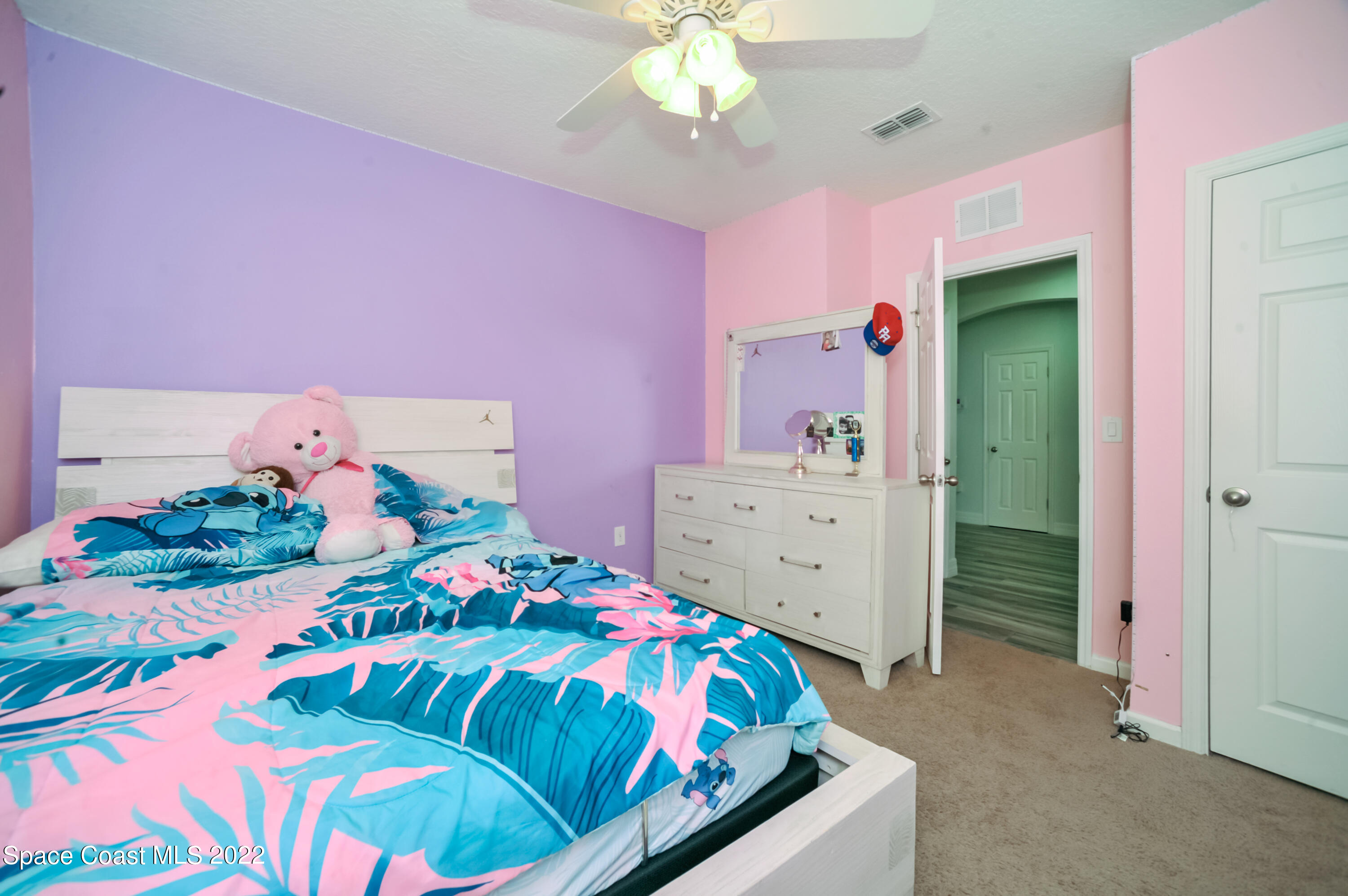4720 Pagosa Springs Circle Melbourne, FL 32901 - Photo 15 of 24 a bedroom with a bed and a dresser in it