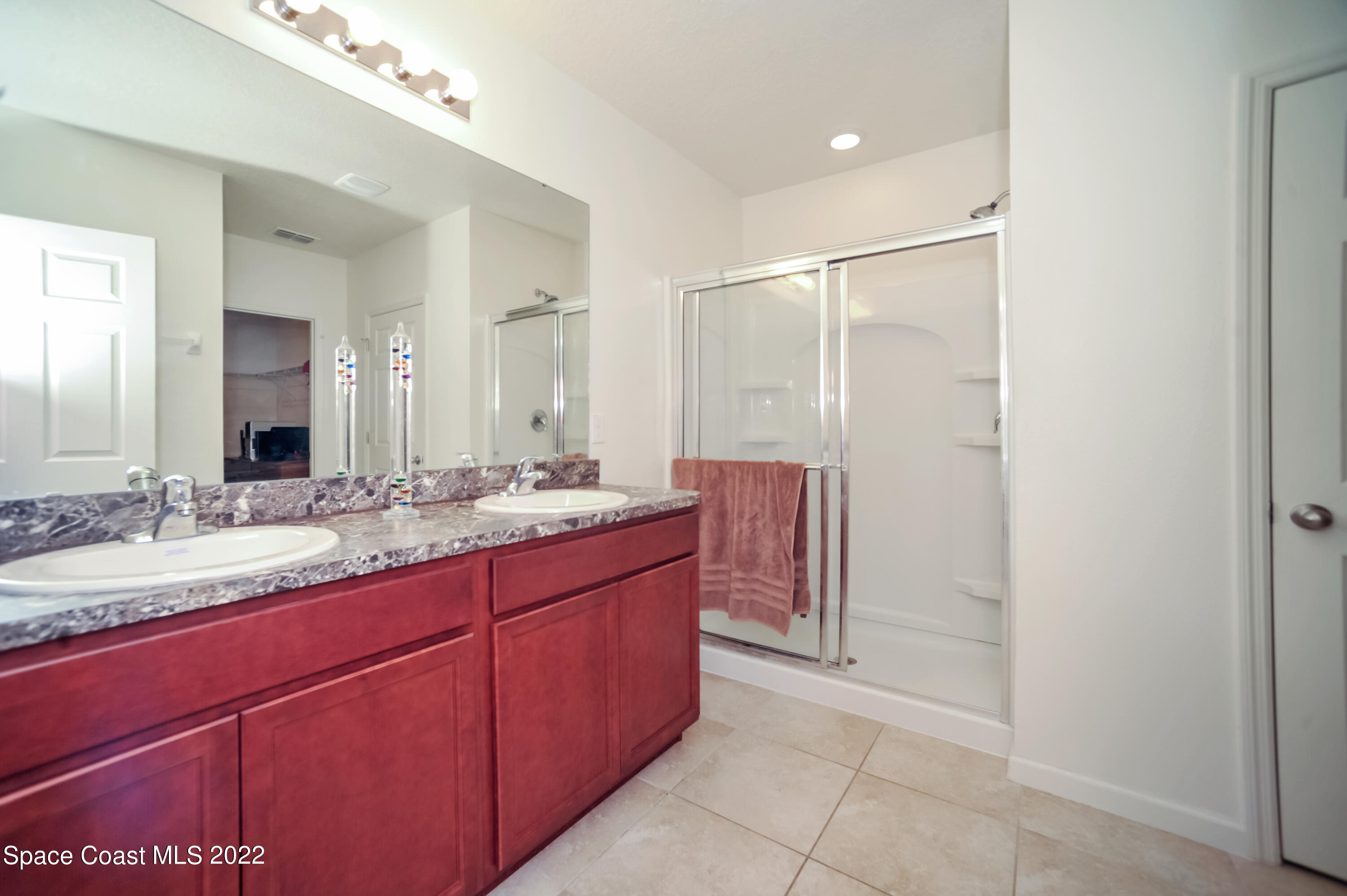 4720 Pagosa Springs Circle Melbourne, FL 32901 - Photo 17 of 24 a bathroom with a granite countertop sink and a mirror