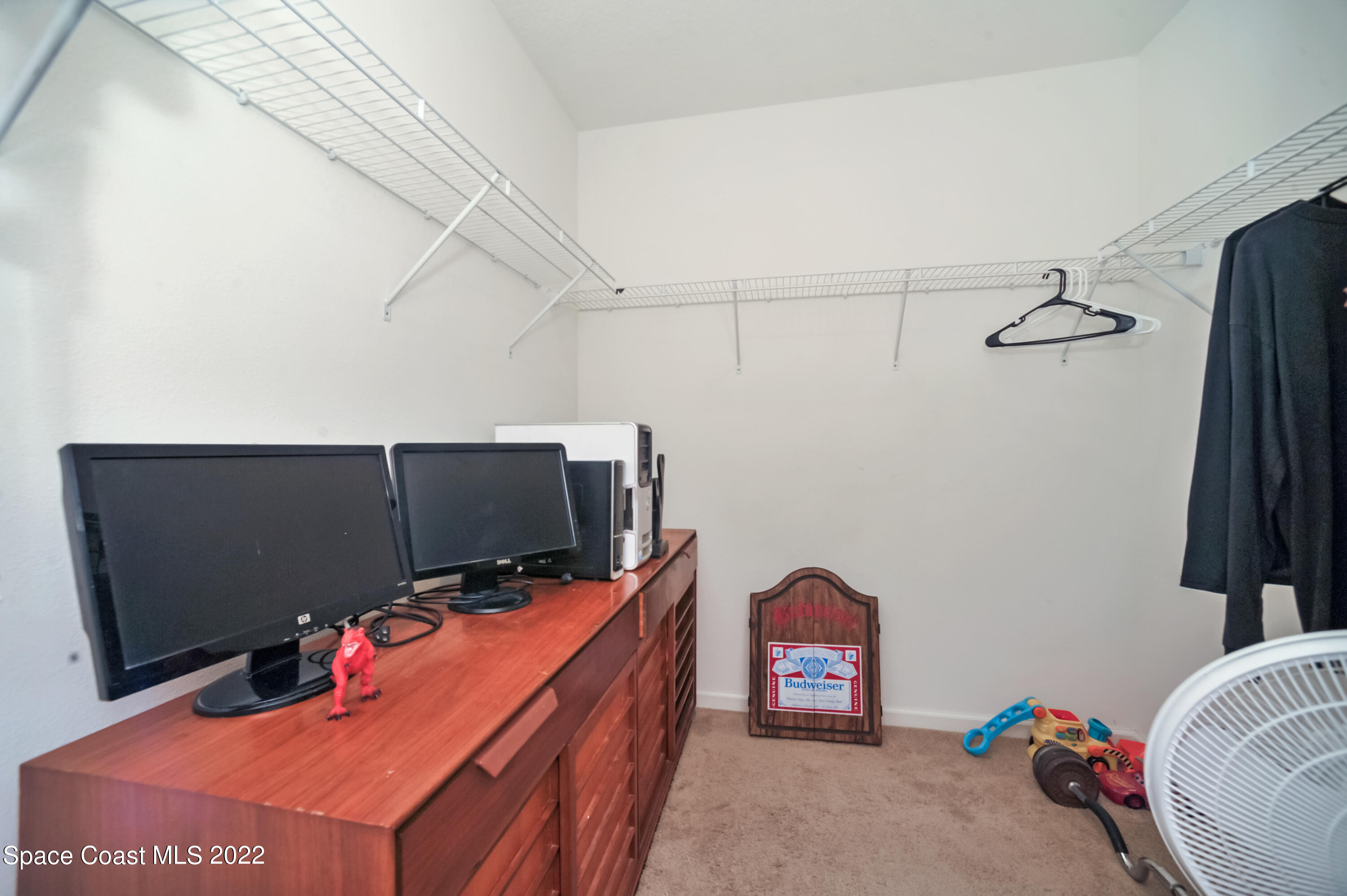 4720 Pagosa Springs Circle Melbourne, FL 32901 - Photo 20 of 24 a living room with a flat screen tv and gym equipment