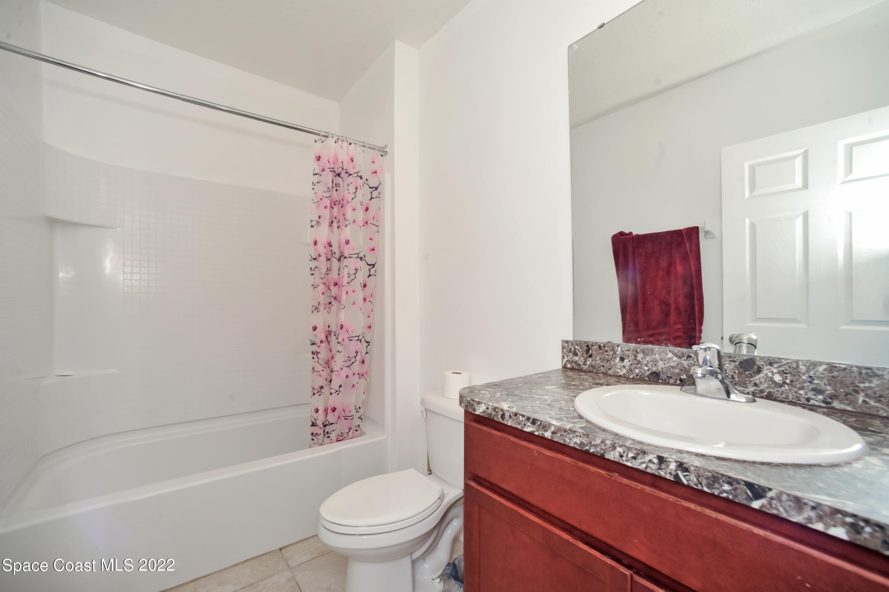 4720 Pagosa Springs Circle Melbourne, FL 32901 - Photo 21 of 24 a bathroom with a granite countertop sink toilet mirror and shower