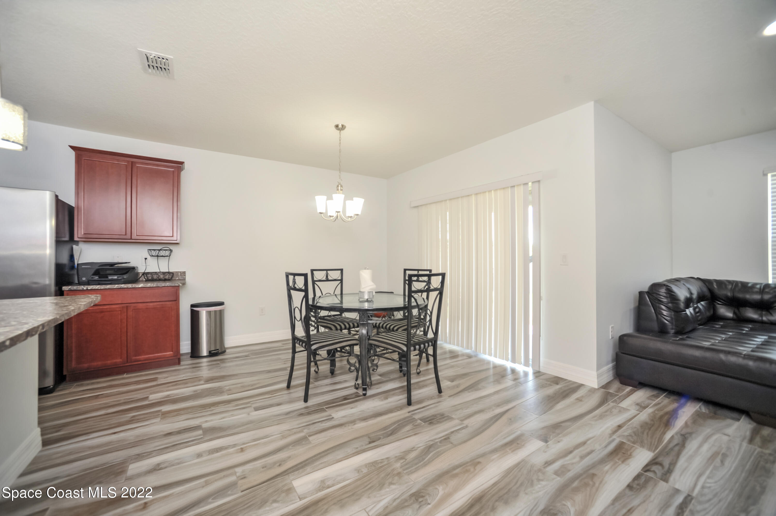4720 Pagosa Springs Circle Melbourne, FL 32901 - Photo 6 of 24 a view of a dining room with furniture and wooden floor