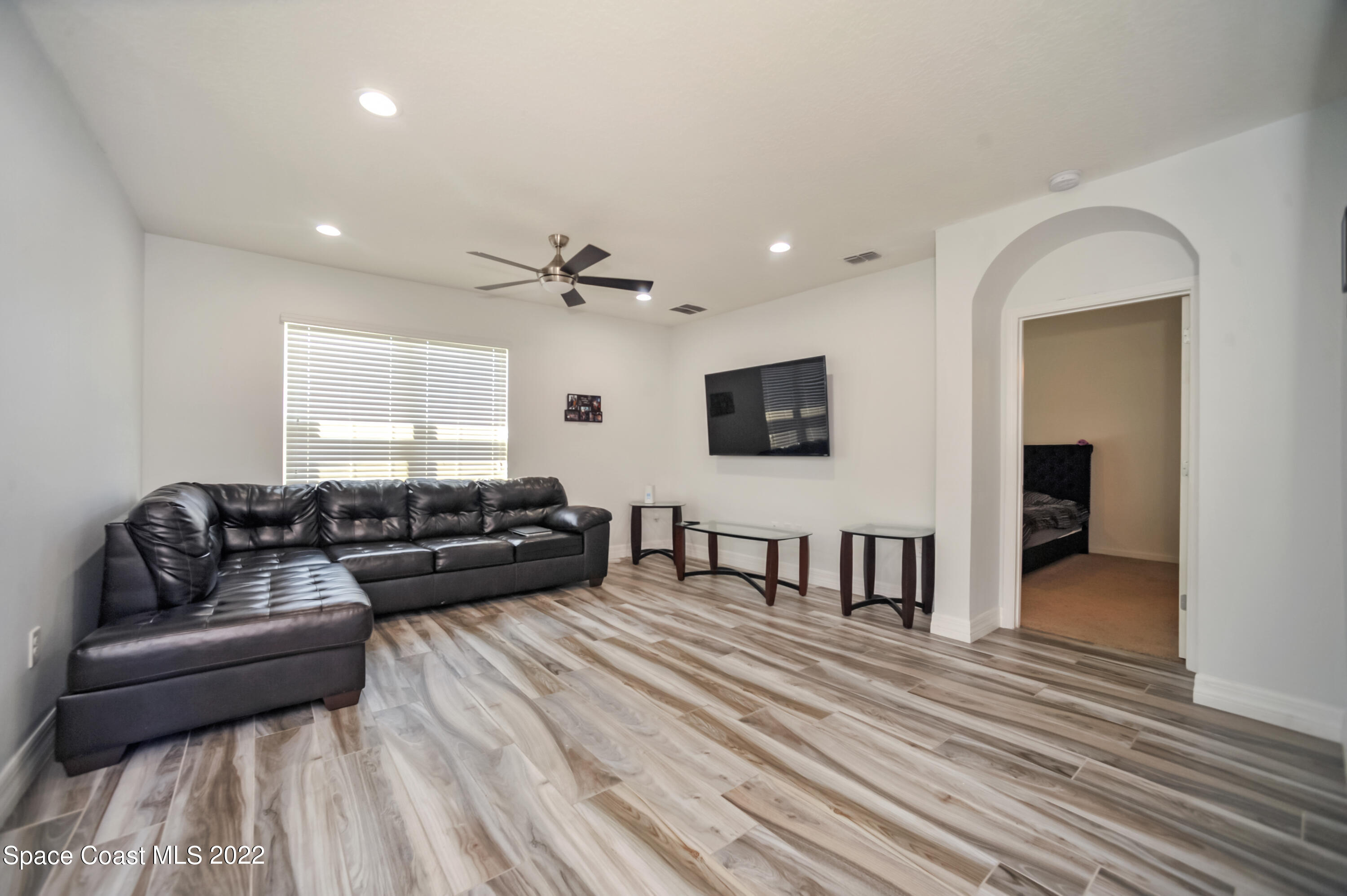 4720 Pagosa Springs Circle Melbourne, FL 32901 - Photo 8 of 24 a living room with furniture and a flat screen tv