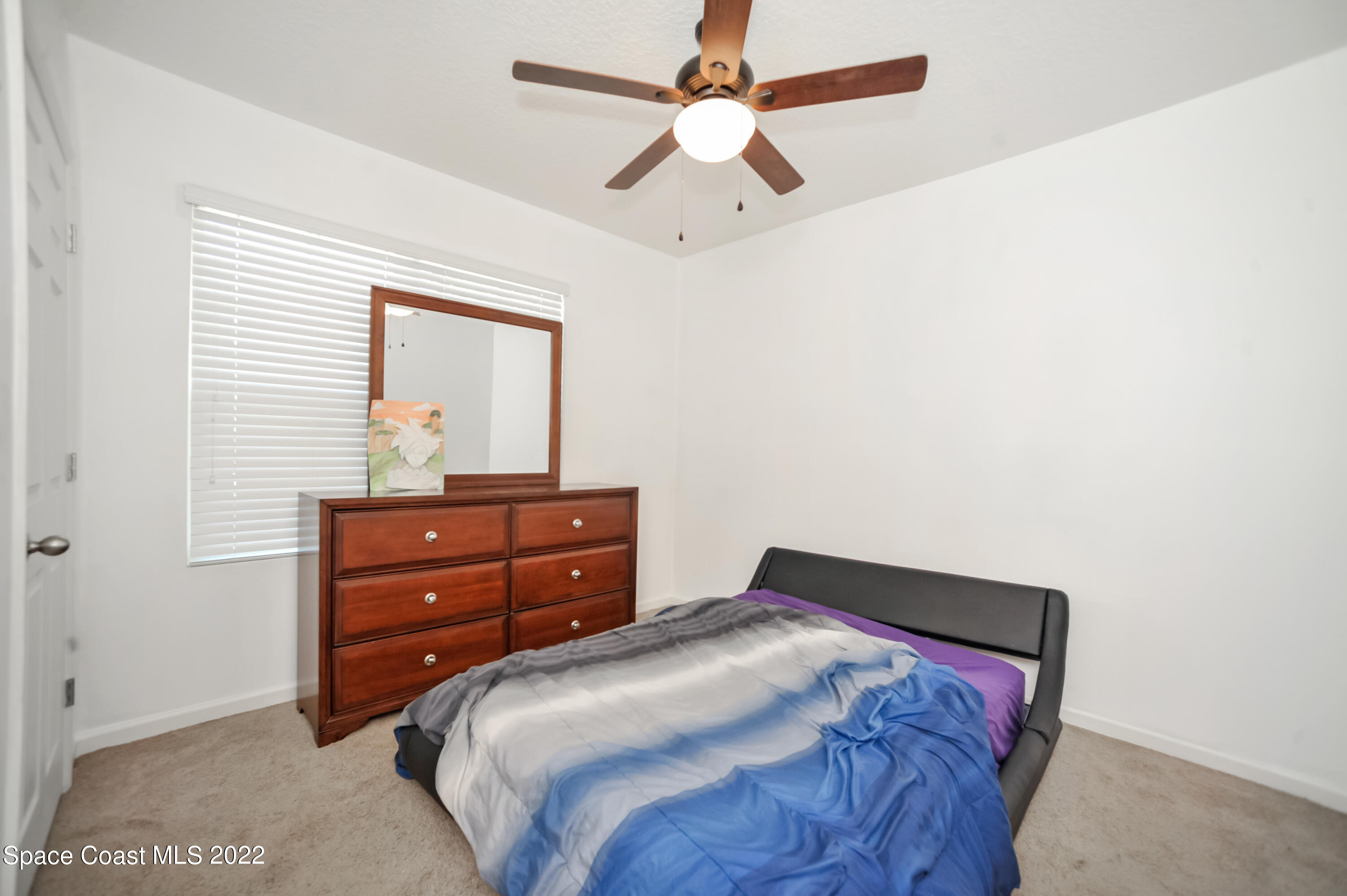 4720 Pagosa Springs Circle Melbourne, FL 32901 - Photo 10 of 24 a bedroom with a bed and a window