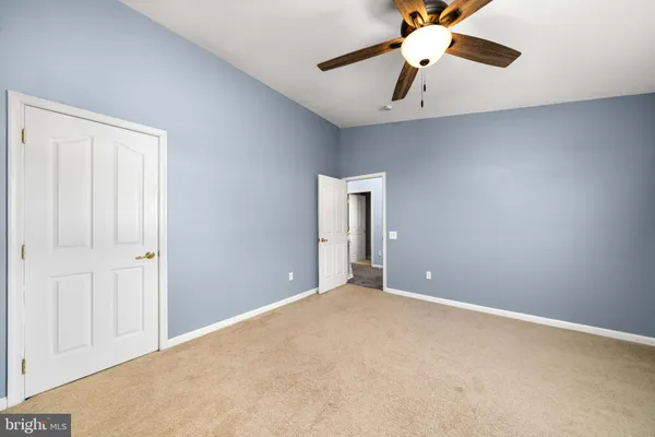 a view of an empty room with a ceiling fan
