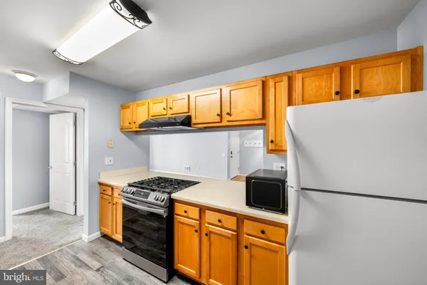 a kitchen with stainless steel appliances a refrigerator and a stove