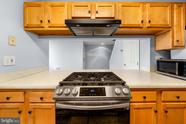 a kitchen with granite countertop a stove and a sink
