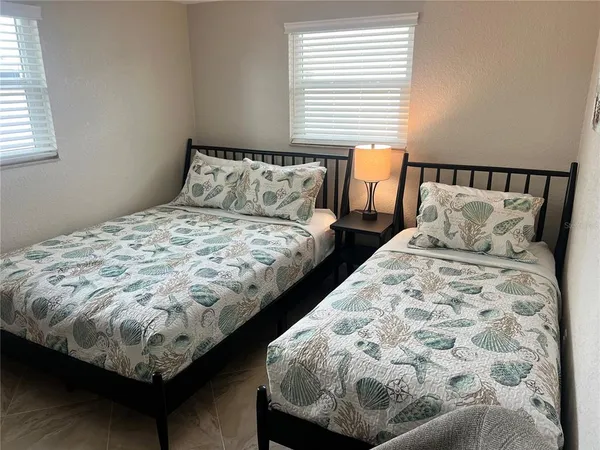 a bed sitting in a bedroom next to a window