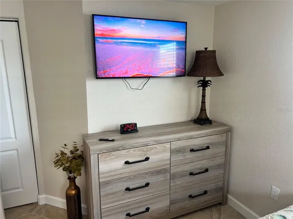 a kitchen with a potted plant on the wall and cabinets