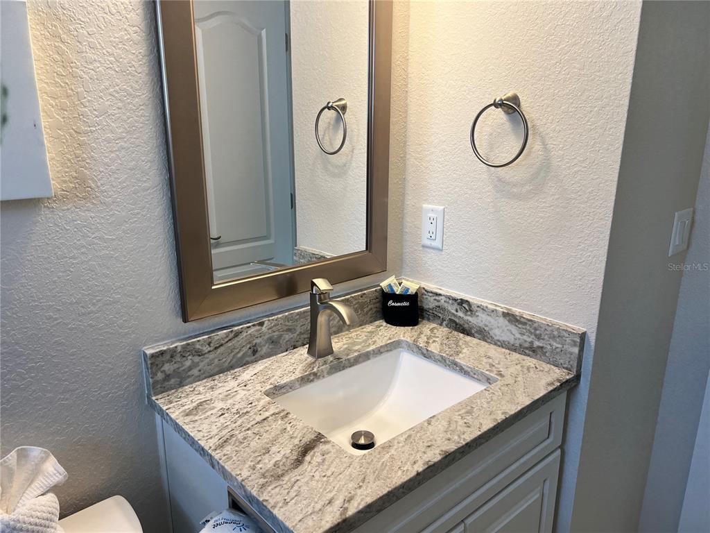 6154 Midnight Pass Road, Unit A14 Sarasota, FL 34242 - Photo 9 of 13 a bathroom with a granite countertop sink and a mirror
