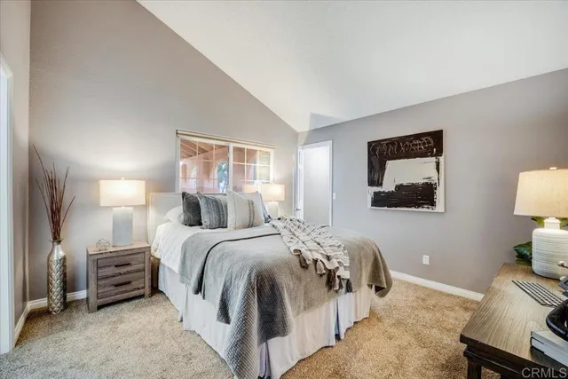 a bedroom with a bed and a lamp on table