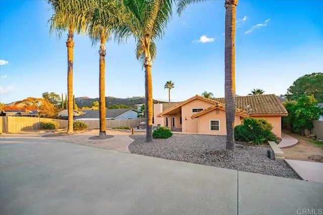 a view of houses with palm trees