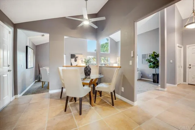 a view of a dining room with furniture and a chandelier fan