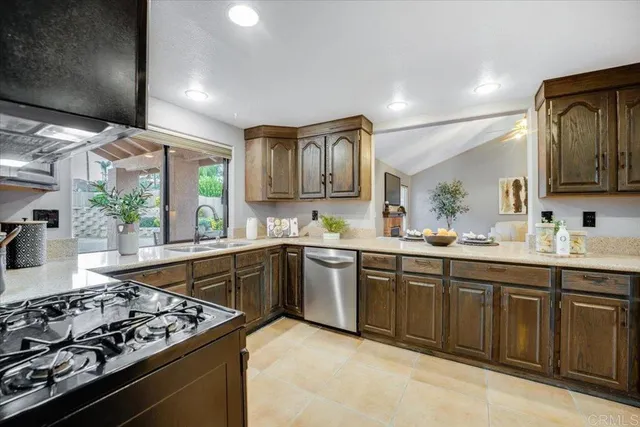 a kitchen with stainless steel appliances granite countertop a stove and a sink