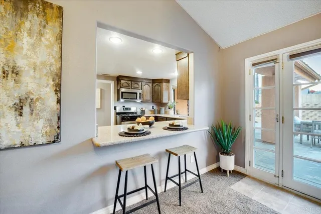 a view of a dining room with furniture and a potted plant