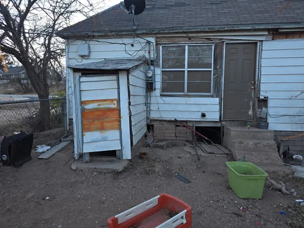 a backyard of a house with barbeque oven