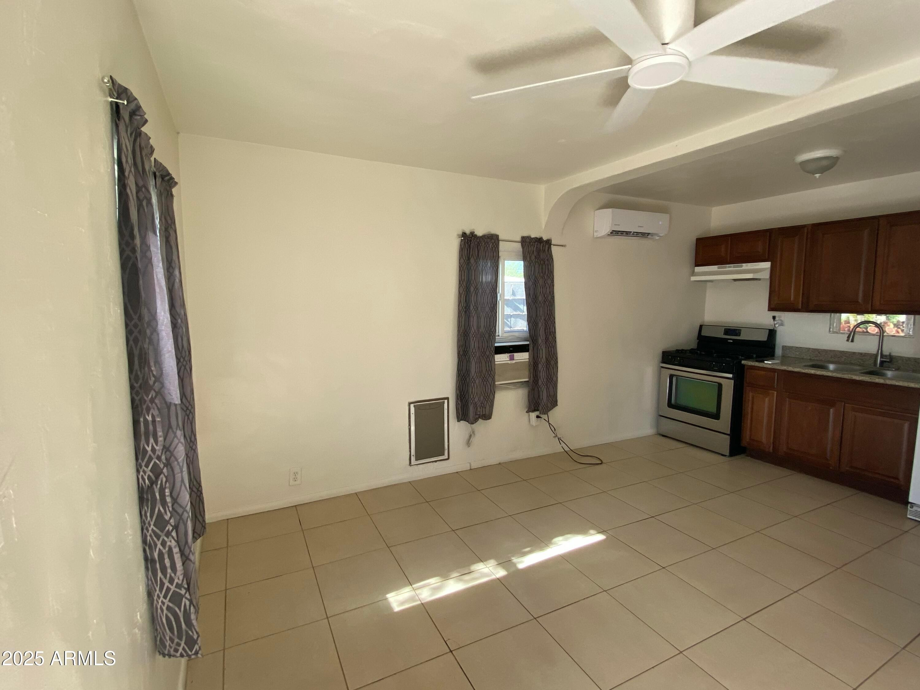 3810 North 9th Place, Unit 1 Phoenix, AZ 85014 - Photo 7 of 7 a kitchen with stainless steel appliances granite countertop a refrigerator and a sink