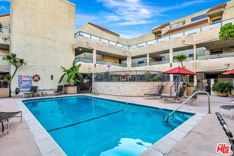a swimming pool with outdoor seating