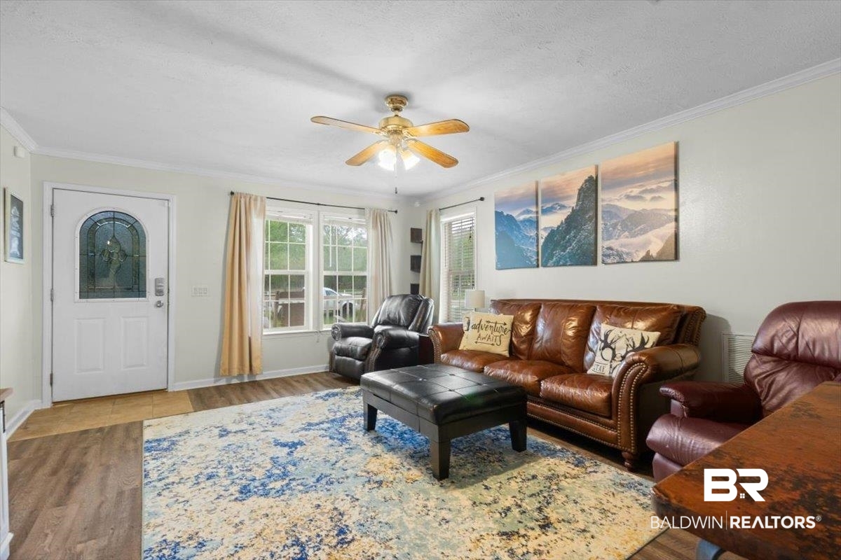 6971 March Road Theodore, AL 36582 - Photo 6 of 26 Living room with ornamental molding, baseboards, ceiling fan, and wood finished floors